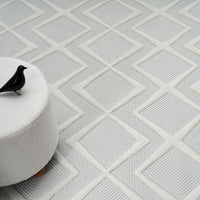White modern rug with textured geometric diamond pattern and subtle raised lines.