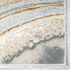 Multi-colored marble patterned modern rug with gray, beige, white, and gold abstract swirls and textured edges.