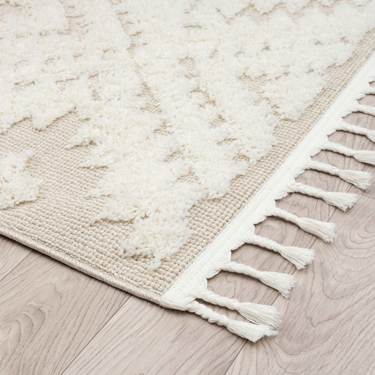 Beige and white modern geometric patterned runner rug with textured pile and fringed edges.