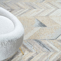 Close-up of a textured rug with a geometric pattern and a white chair corner.