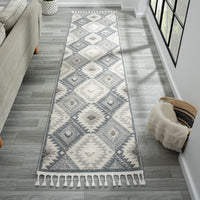 Grey and cream runner rug with modern geometric diamond pattern and fringed edges.