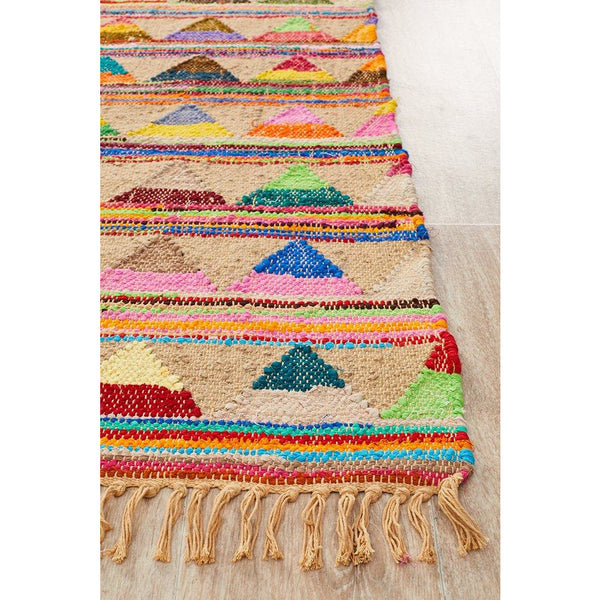 Hand-woven jute and cotton rug with vibrant geometric patterns and fringed edges.