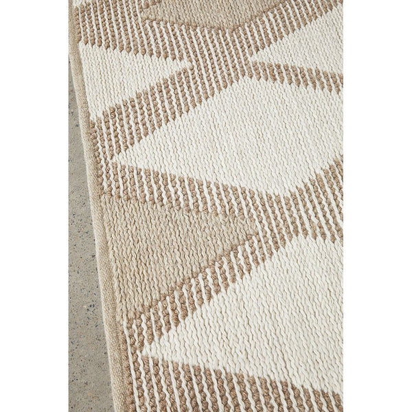 Natural wool and cotton rug with light neutral diamond pattern and textured weave.