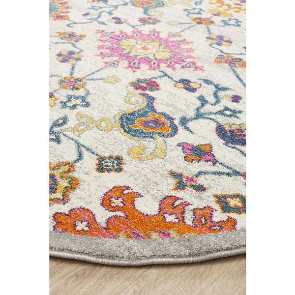 Round Bohemian-inspired rug with multicolored floral and abstract patterns on a light background.