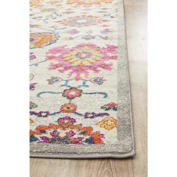 Bohemian-inspired rug with multicolor abstract floral patterns and a soft gray border.