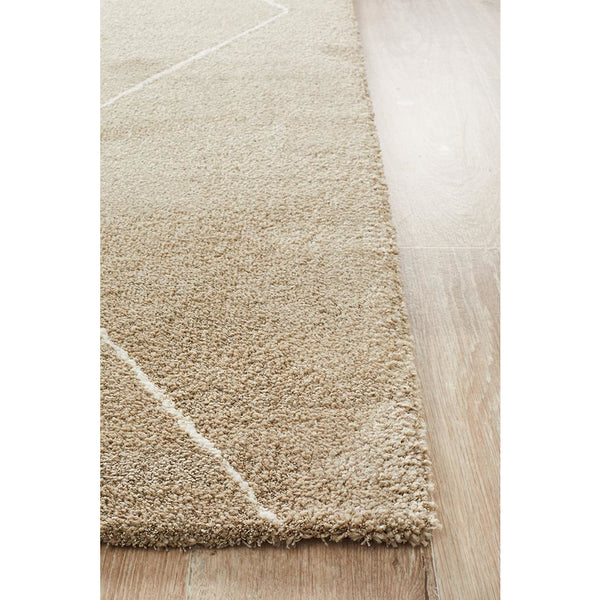 Natural beige plush rug with subtle geometric line pattern on light wood floor.