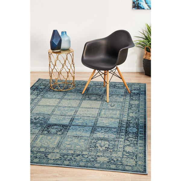 Blue grey and beige patchwork rug with floral motif border in modern design.