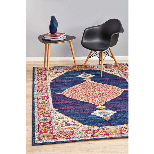 Blue and purple transitional medallion patterned rug with intricate multi-color border.