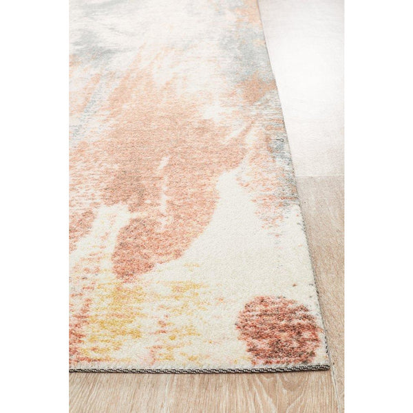 Abstract modern rug in watercolor blue and rust tones with soft blended pattern on light background.