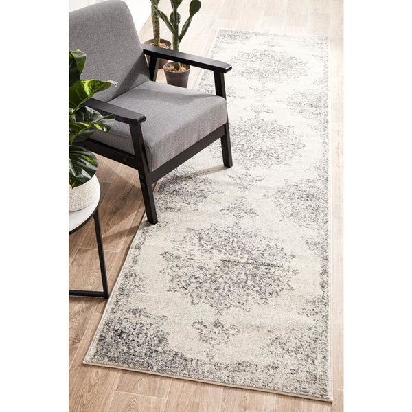 Silver grey and cream transitional runner rug with medallion and subtle tribal patterns on light background.