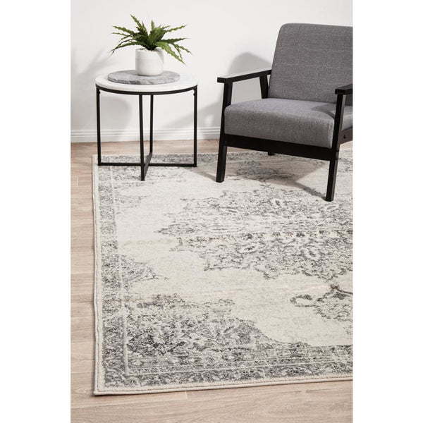 Silver grey and cream transitional rug with intricate medallion pattern on hardwood floor.