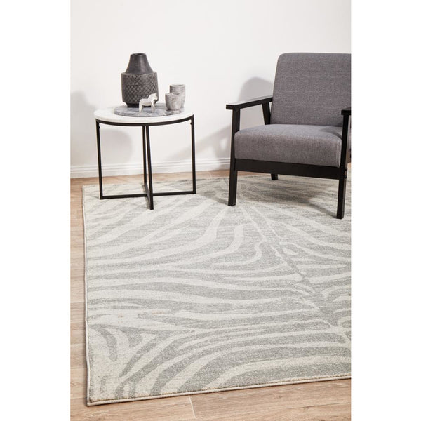 Silver grey and cream rectangular rug with subtle zebra-inspired animal pattern and textured pile.