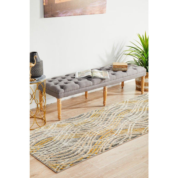 Charcoal and multi-colored abstract runner rug with wavy pattern on light hardwood floor.