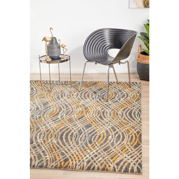 Charcoal and multi-color Potenza 492 rug with abstract curved pattern on hardwood floor.