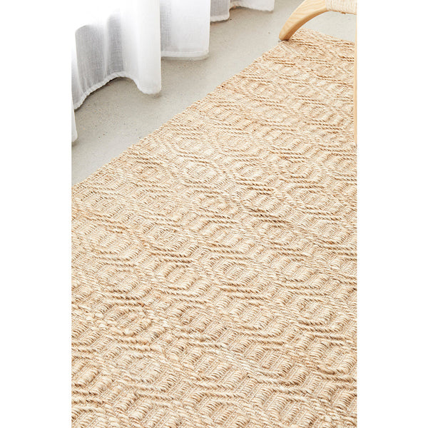 Natural beige jute and cotton rug with textured geometric diamond pattern, flatwoven style.