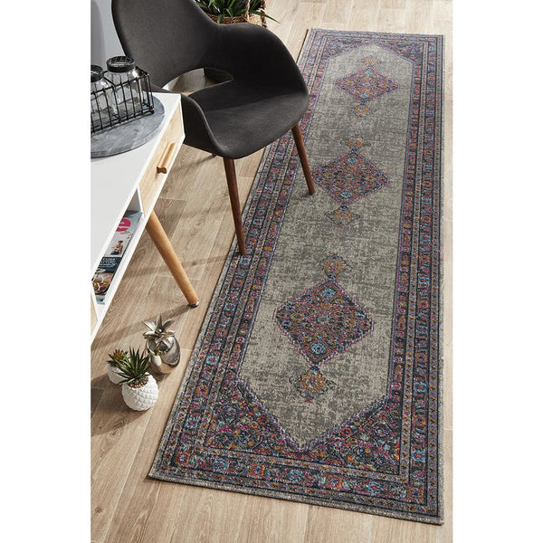 Grey transitional patterned runner rug with multi-colored diamond motifs and detailed border.