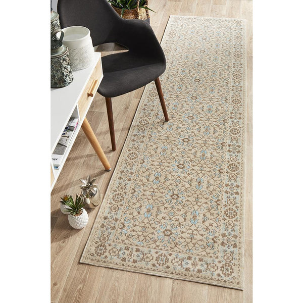 Bone beige transitional runner rug with intricate patterned design in soft blue and tan tones on hardwood floor.
