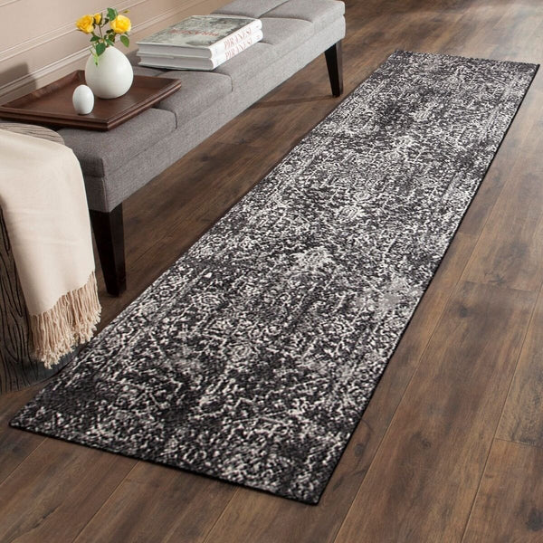Charcoal and grey transitional runner rug with abstract patterned design on hardwood floor.