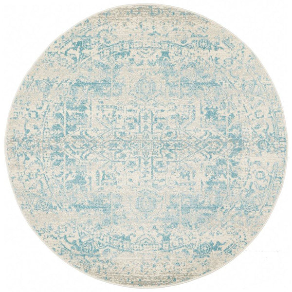 Round beige and light blue transitional rug with intricate faded medallion pattern.