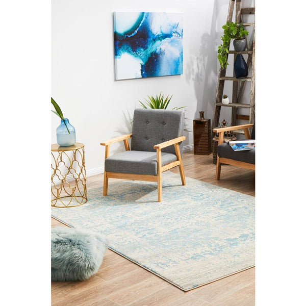 Beige and light blue transitional rug with subtle abstract pattern on wooden floor.
