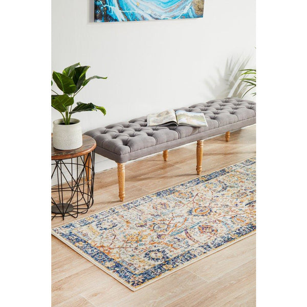 Ivory runner rug with navy and beige intricate border and multicolor bohemian pattern, power-loomed polypropylene.