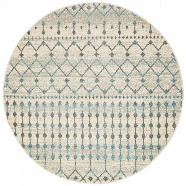 Round beige rug with blue-grey geometric and dotted pattern in a transitional style.