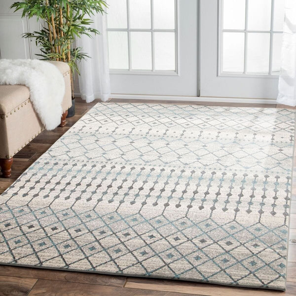 Blue, grey, and beige patterned transitional rug with geometric and diamond designs on a hardwood floor.