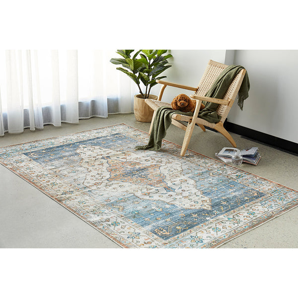 Blue multi-colored bohemian rug with intricate geometric patterns in a modern living space.