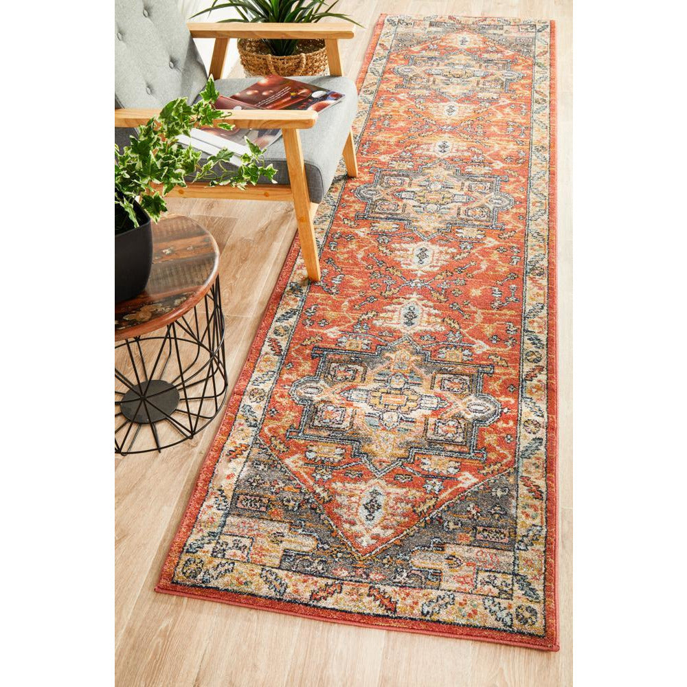 Terracotta multi-color runner rug with intricate tribal and bohemian patterns on hardwood floor.