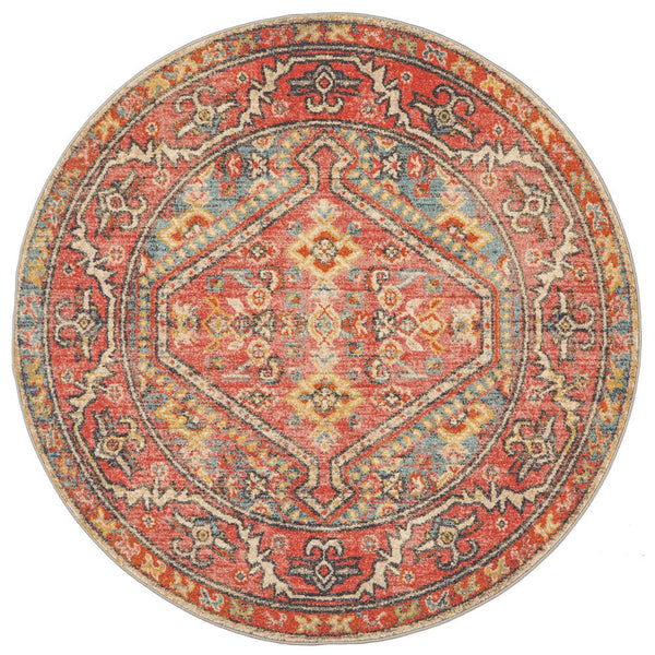 Round transitional rug with crimson, red, gold, and blue tribal patterns on polypropylene fiber.