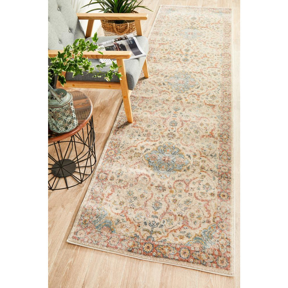 Multi-colored transitional runner rug with intricate aztec and tribal-inspired patterns in cream, blue, and earthy tones.