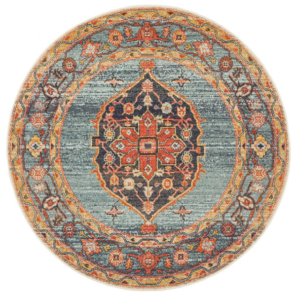 Round transitional rug with rust, blue, and multi-color tribal pattern on a textured polypropylene surface.