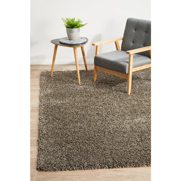 Grey shaggy rug with thick polypropylene pile in a modern living room setting.
