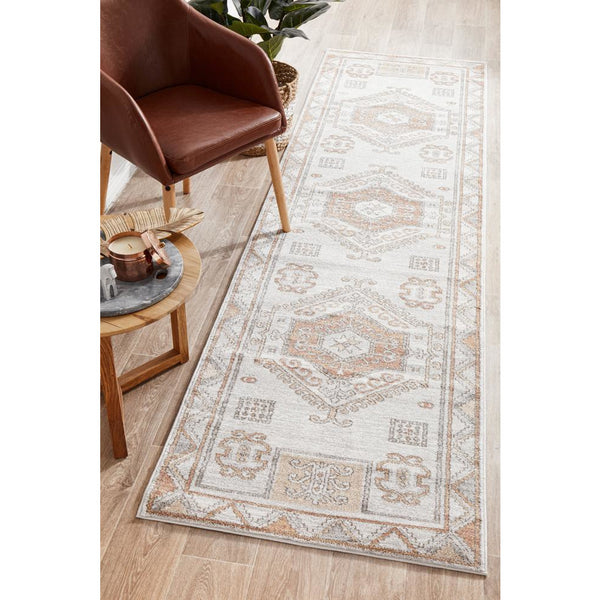 Transitional runner rug with peach and natural white medallion pattern on a polypropylene base.