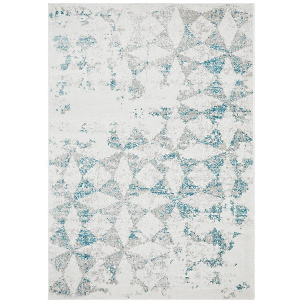 Modern abstract rug with blue, beige, and grey diamond shapes on a white background.