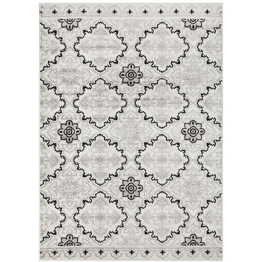 Modern floral abstract rug with black and grey patterns on beige background.