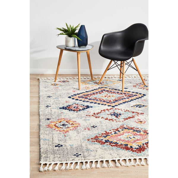 Silver grey Ankara rug with modern tribal patterns and multicolored accents, fringed edges.