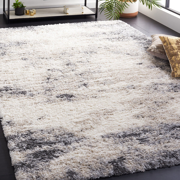 Modern patterned shaggy rug in soft white and gray abstract design with plush polypropylene pile.