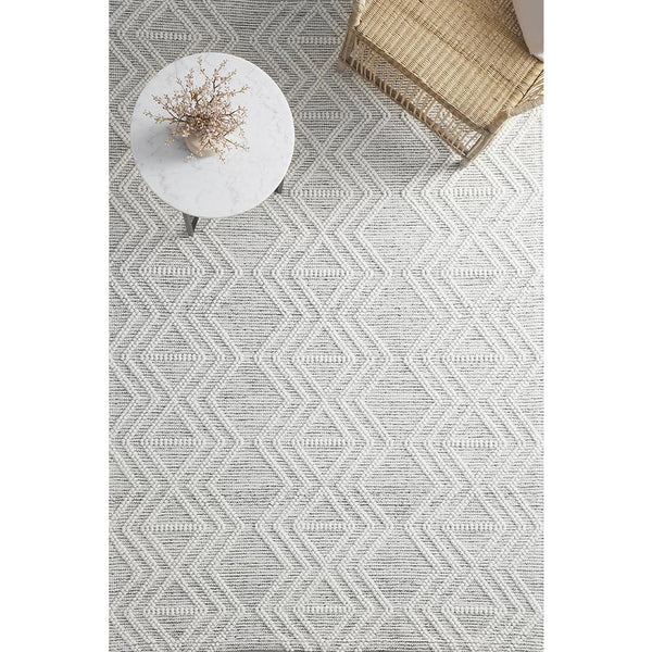 Ivory and black modern hand-loomed wool blend rug with geometric tribal pattern.