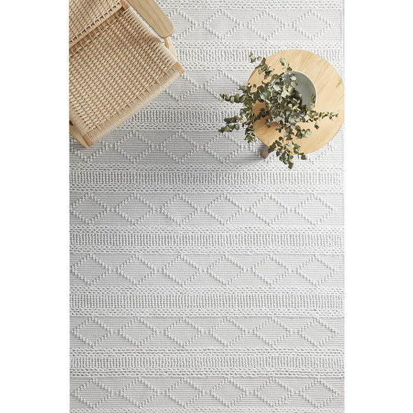 Ivory hand-loomed wool blend rug with subtle geometric diamond and stripe texture.