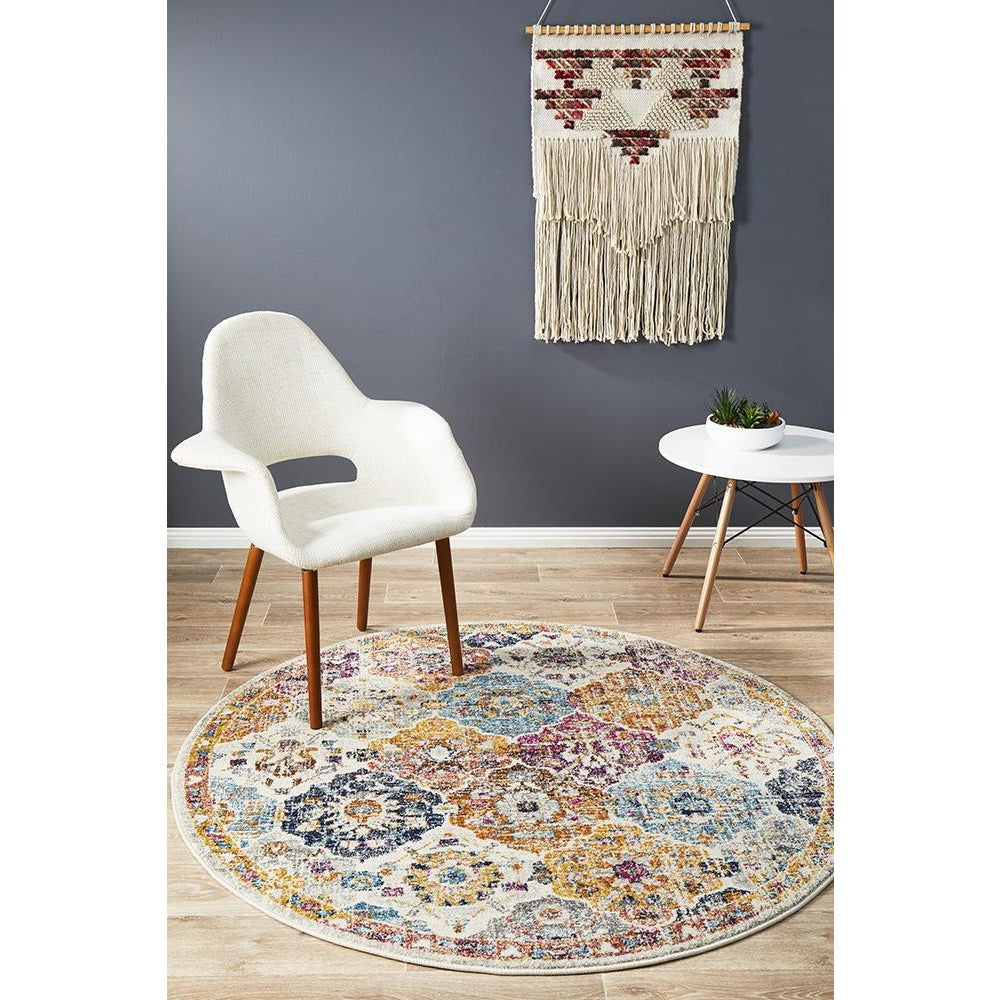 Round multi-coloured bohemian rug with intricate circular patterns in a light room setting.
