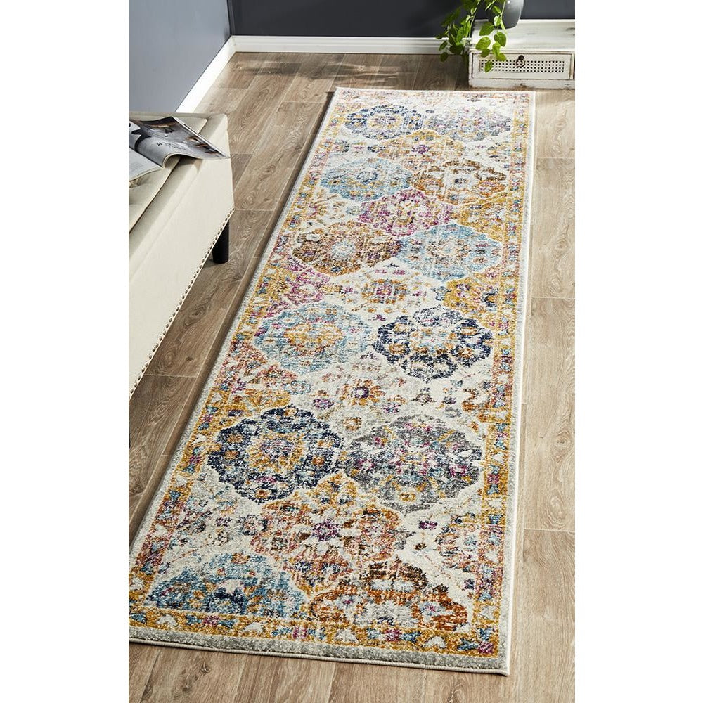 Multi-colored transitional bohemian runner rug with intricate floral and geometric patterns on a light background.
