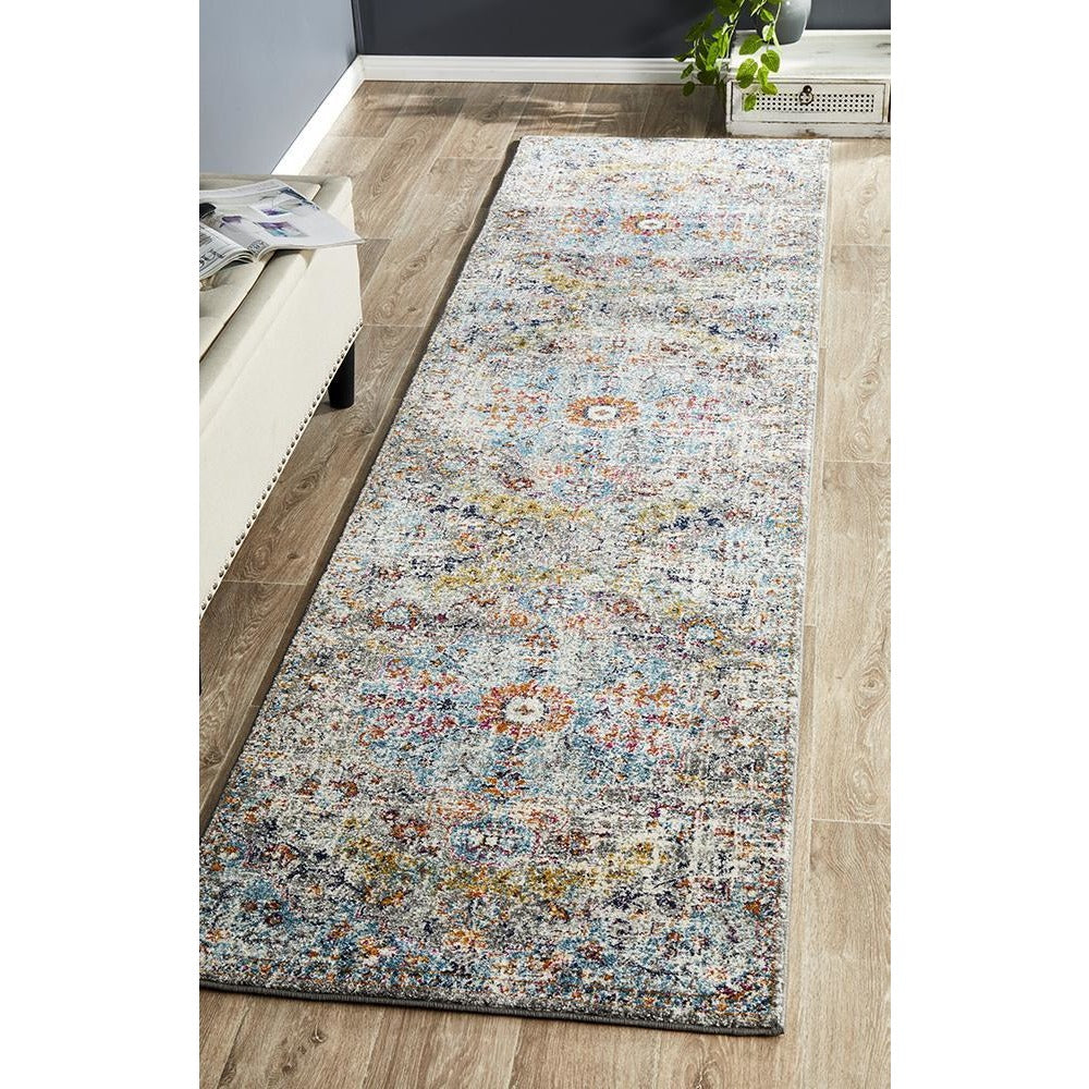 Multi-color transitional bohemian runner rug with intricate floral and geometric patterns on light background.