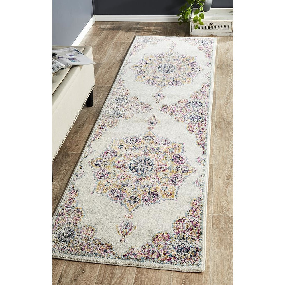 Transitional bone runner rug with multicolored bohemian medallion patterns on light background.