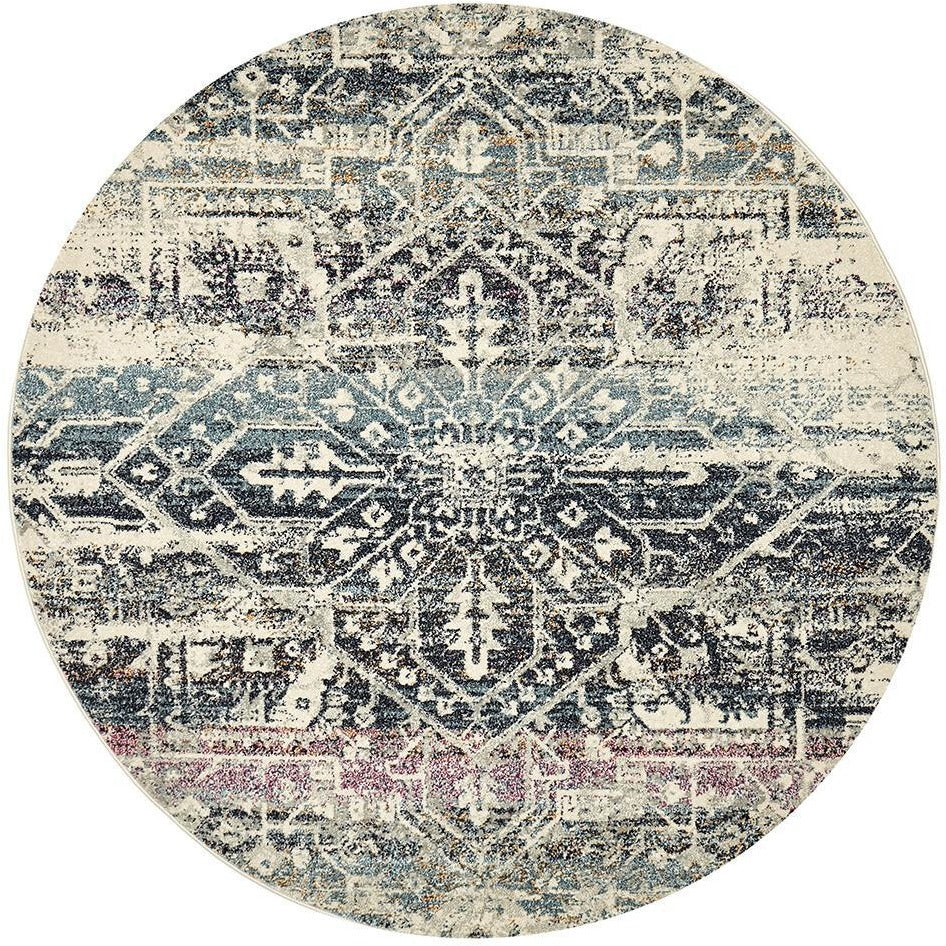 Round transitional bohemian rug with navy blue, cream, and subtle mauve geometric pattern.