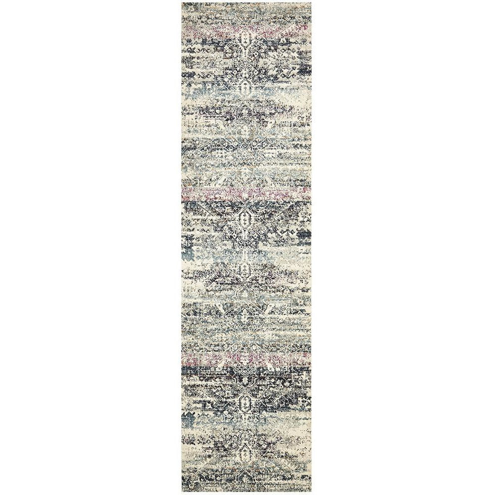 Long transitional bohemian runner rug with muted blue, gray, and soft pink intricate patterns on a textured background.