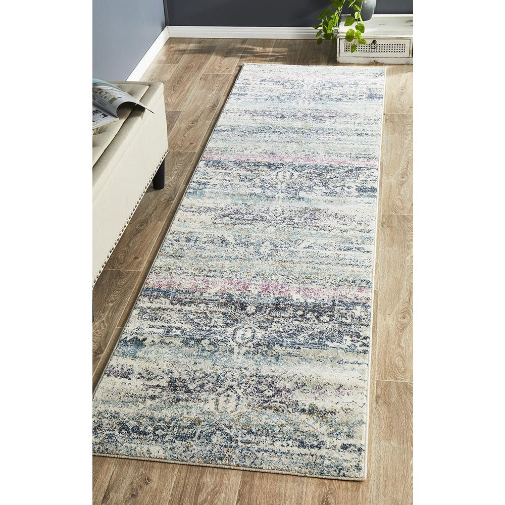 Bohemian blue patterned transitional runner rug on light wood floor.