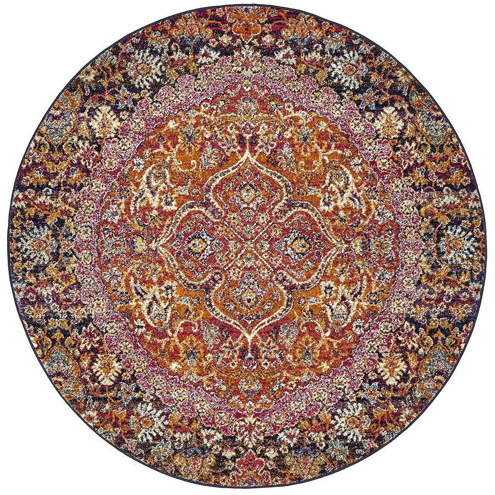 Round bohemian rug with intricate pink, rust, and multi-colored floral and medallion patterns.