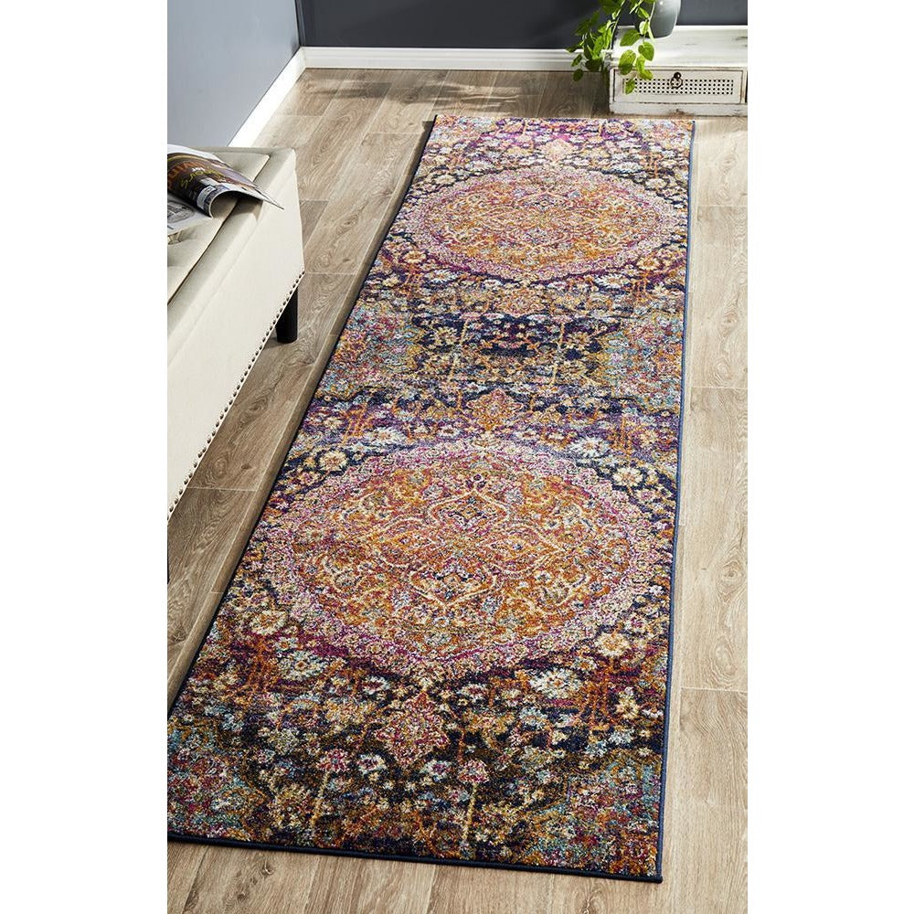 Bohemian runner rug with pink, rust, and multi-color medallion patterns on dark background.