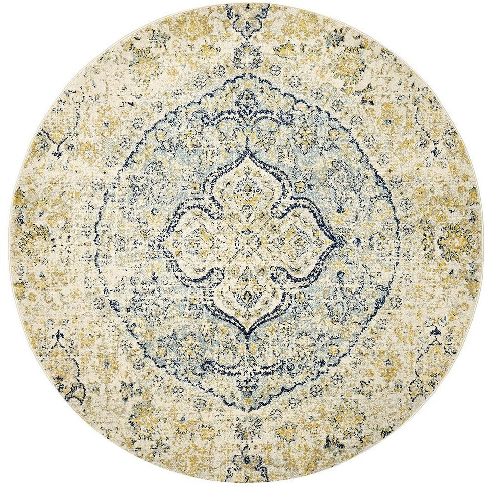Round bohemian rug with blue and beige intricate floral medallion pattern on a distressed background.